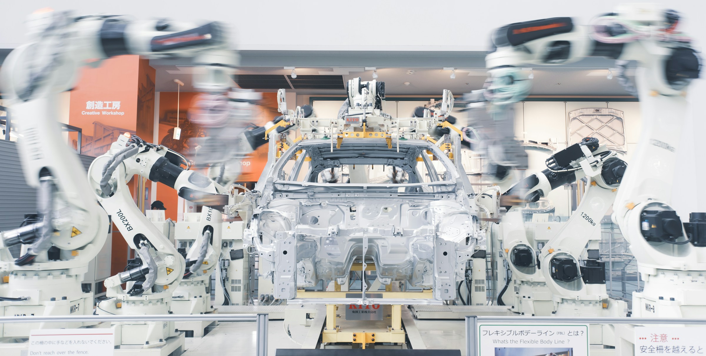 Robotic arms working around an automotive assembly line